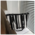 Detail of vertical striped canvas tote bag with black leather trim and metal rivets - Black Fine Lines