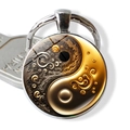 Close-up of artistic yin-yang glass dome keychain with gold and black fluid art design - Black Gold Artistic Spiral Style (JY009351-12)