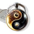 Macro view of yin yang glass keychain showing artistic gold fire and black smoke texture - Gold Flame and Black Smoke Style (JY009351-10)