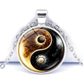Macro shot of Yin Yang pendant necklace with golden artistic flame pattern on white background - Gold and Black Flame Style (JY009349-10)