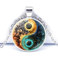 Detailed close-up of Yin Yang Tai Chi glass cabochon pendant with cosmic nebula art design - Yellow and Blue Universe Style (JY009349-8)