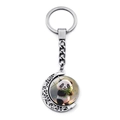 Close-up of rotating moon-shaped panda keychain with decorative hollow patterns - 3D Cartoon Panda Style (JY009363-10)