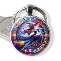 Detailed view of witch riding broom on a glass cabochon keychain with alloy border - Painted Witch Flight(JY009410-8)