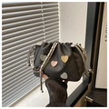 Detail of black pleated bucket bag with pastel heart patches and silver chain strap - Black
