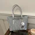 Silver pleated bucket tote bag with plush doll charm on a minimalist desk setup - Silver With Pendant