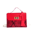 Red crossbody bag with black snake pattern base and golden chain strap for women - Red