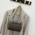 Vintage brown flower print cylinder bag with beige wide strap over a grey blazer - Coffee