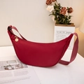 Minimalist red crescent dumpling bag with matching strap and golden zipper detail - Red