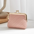 Pink vintage woven coin purse with gold kiss-lock closure in a minimalist home setting - Pink