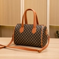 Classic Boston barrel bag featuring dark leather with gold floral print and brown straps - Brown