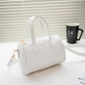 Modern white quilted Boston bag with gold hardware and a detachable shoulder strap - Quilted White