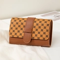 Brown leather bi-fold short wallet with clover pattern print and a stylish buckle closure - Brown