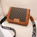 Vintage brown crossbody bag with logo strap and gold twist lock on fabric sofa - Brown