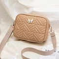 Beige quilted crossbody camera bag with white butterfly clasp and wide woven strap - Apricot