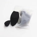 Detalle de dos esponjas de maquillaje negras en bolsa esmerilada y caja clara - Huevo Cohete Negro Con Forma De Mini Lágrima (bolsa Esmerilada)
