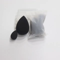 Detail of two black beauty sponges in different sizes with clear storage box and pouch - Beveled Teardrop And Mini Teardrop
