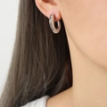 Silver C-shape hoop earring with geometric mesh scale texture on a model's ear - Mesh Silver