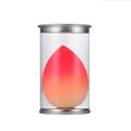 Gradient red-orange teardrop makeup sponge in a clear cylinder case with silver lids - Tinplate Box / Skin Gradient