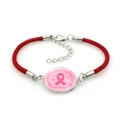 Close-up of pink ribbon breast cancer awareness charm on a red braided rope bracelet - Breast Cancer Awareness Style (Red-11)