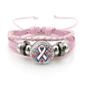 Detail of pink breast cancer awareness leather bracelet with ribbon glass cabochon - Blooming Ribbon