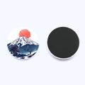 Detail of Mount Fuji fridge magnet showing front sunrise art and back magnetic surface - Jy9464-6