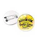 Detail view of the yellow inspirational round badge showing the pin back and front design - Isaiah 41:13 / Silver