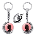 Detail of 360-degree rotating moon keychain with Elphaba and Glinda silhouettes - Girl Silhouette Style (JY009516-2)