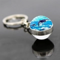 Macro shot of double-sided glass ball keychain featuring a jumping orca sea animal design - Orca Deep Blue Leaping Style (JY9534-12)