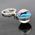 Detail of a dolphin glass cabochon keychain with a sunset orca illustration and metal base - Orca Pink Purple Sunset Style (JY9534-9)
