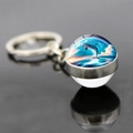 Macro shot of double-sided glass ball dolphin keychain with silver metal ring and reflection - Rainbow Dolphin Leaping Style (JY9534-6)
