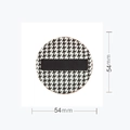 Detailed view of 54mm round houndstooth cushion puff with black finger ribbon - L Round / Box Packaging