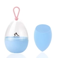 Detail of sky blue makeup sponge with matching egg-shaped storage case and silicone handle - Slanted Cut Shape / Blue