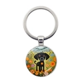 Detailed close-up of a silver keychain with an artistic black dog cartoon illustration - Black Puppy with Floral Mountain Background (JY9602-5)