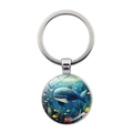 Detail of round silver keychain pendant with cartoon whale illustration on deep blue background - Whale Pattern (JY9606-6)
