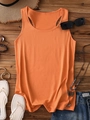 Flat lay of orange racerback tank top with denim shorts and summer vacation accessories - Light Orange