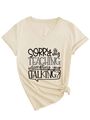 Detail of V-neck apricot T-shirt featuring SORRY IS MY TEACHING slogan and knotted hem - S / Sand