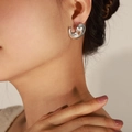 Polished silver droplet earrings with a minimalist geometric design on model - Steel Color Earrings (F411)