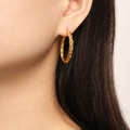Detail of twisted rope gold earrings worn by a model showcasing texture and finish - Twisted Rope Style (F1420) / Gold