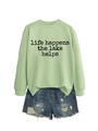 Détail du sweat vert menthe avec texte imprimé et short en jean bleu délavé - Vert Olive (Police Noire)