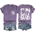 Flat lay of purple V-neck t-shirt with Sun Salt Sand print and distressed denim shorts - S / Purple