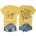 Flat lay view of a bright yellow graphic T-shirt and distressed denim shorts outfit set - Yellow (Black Graphic)