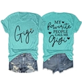 Detailed view of turquoise Gigi T-shirt back with slogan and distressed denim shorts - Deep Water Blue (Black Graphic)