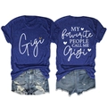 Detailed flat lay of navy Gigi t-shirt with rolled sleeves and distressed denim shorts - Retro Blue (White Graphic)
