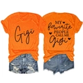Front and back detail of orange Gigi graphic t-shirt and distressed denim shorts - Orange (Black Graphic)