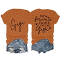 Flat lay of Gigi graphic orange T-shirt and distressed denim shorts set on white background - Rust Orange (Black Graphic)