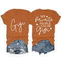 Detailed front and back view of orange Gigi printed T-shirt and ripped denim shorts - Rust Orange (White Graphic)