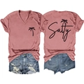 Detailed view of pink V-neck T-shirt with Salty palm tree print and denim shorts - Rose Gold (Black Font)