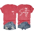 Flat lay of red V-neck T-shirt with palm tree print and distressed denim shorts set - Red