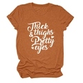 Detail of caramel t-shirt featuring Thick & Thighs Pretty Eyes letter print and heart graphic - S / Burnt Orange