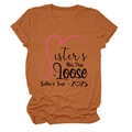 Detail of Sisters On The Loose 2025 print on rust red round neck cotton t-shirt - S / Tops / Burnt Orange (Black Text)